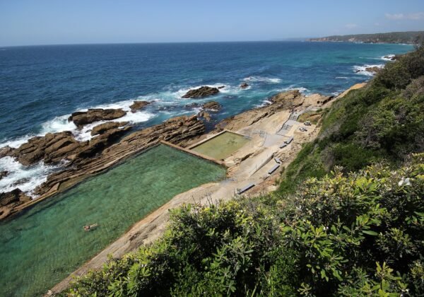 The Blue Pool ocean pool carved into the rock shelf below the headland at Bermagui NSW