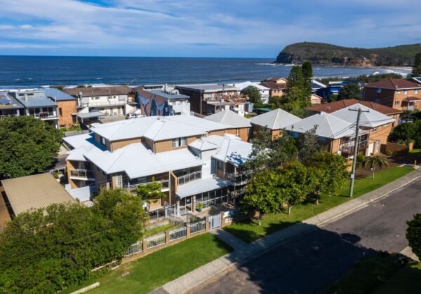 Aerial view of Copacabana Shores motel beside Copacabana Beach, NSW Central Coast