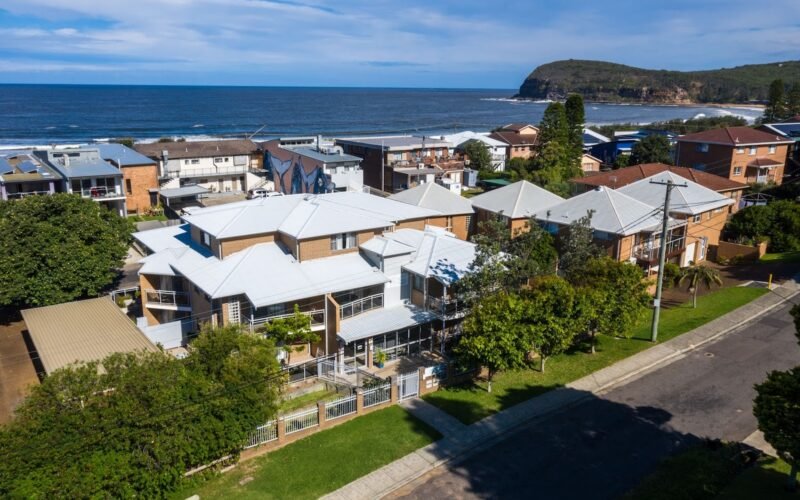 Aerial view of Copacabana Shores motel beside Copacabana Beach, NSW Central Coast