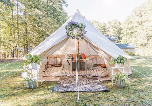 A furnished glamping bell tent set up outdoors