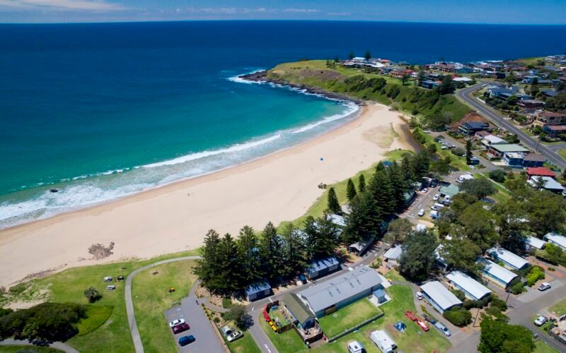 Aerial view of Kendalls On The Beach Holiday Park beside Kiama beach, NSW