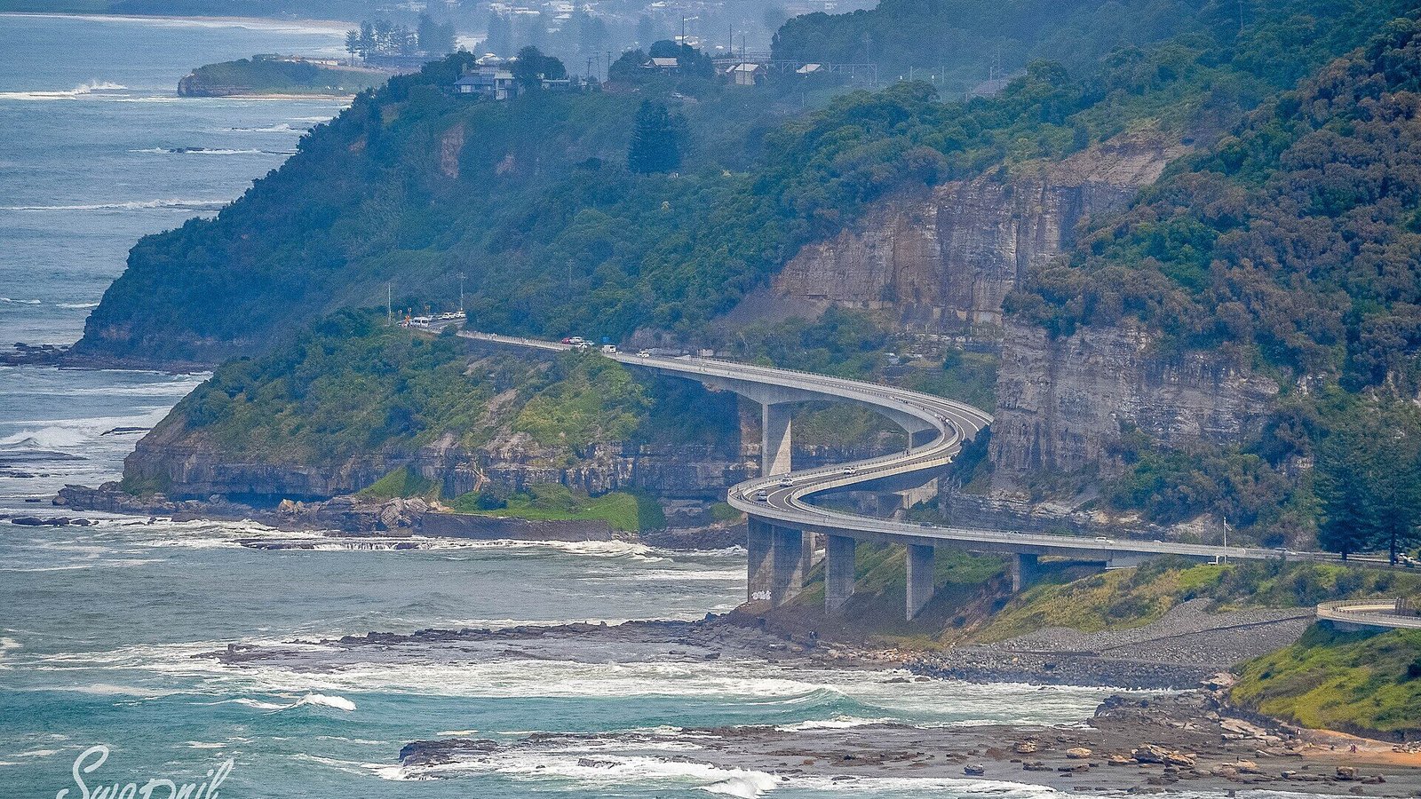 The Sea Cliff Bridge curving off the escarpment over the ocean, Grand Pacific Drive NSW
