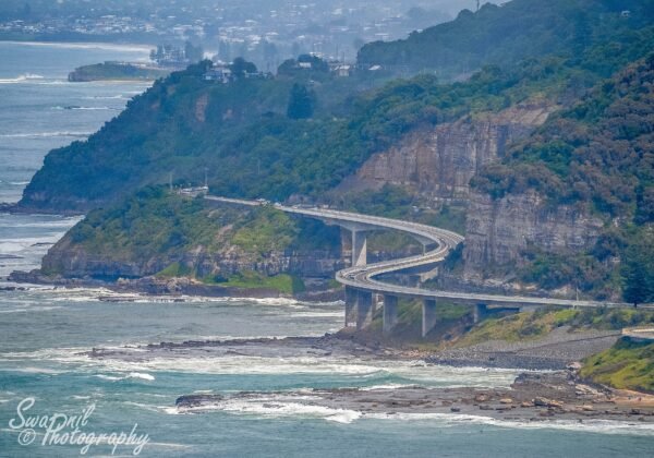 The Sea Cliff Bridge curving off the escarpment over the ocean, Grand Pacific Drive NSW