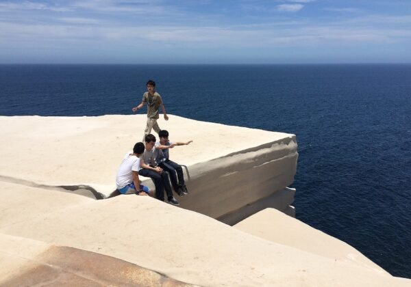 The stark white sandstone slab of Wedding Cake Rock above the ocean, Royal National Park NSW
