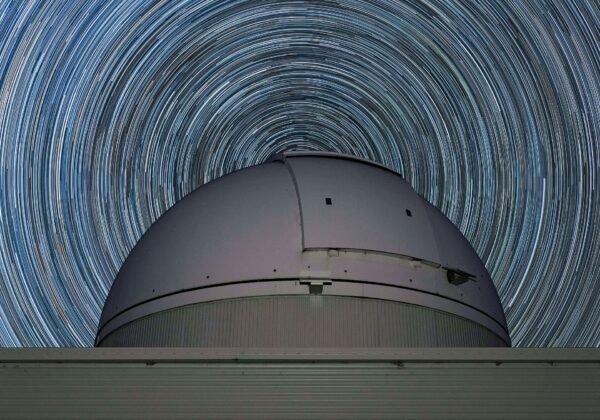 Star trails over an observatory dome in rural NSW